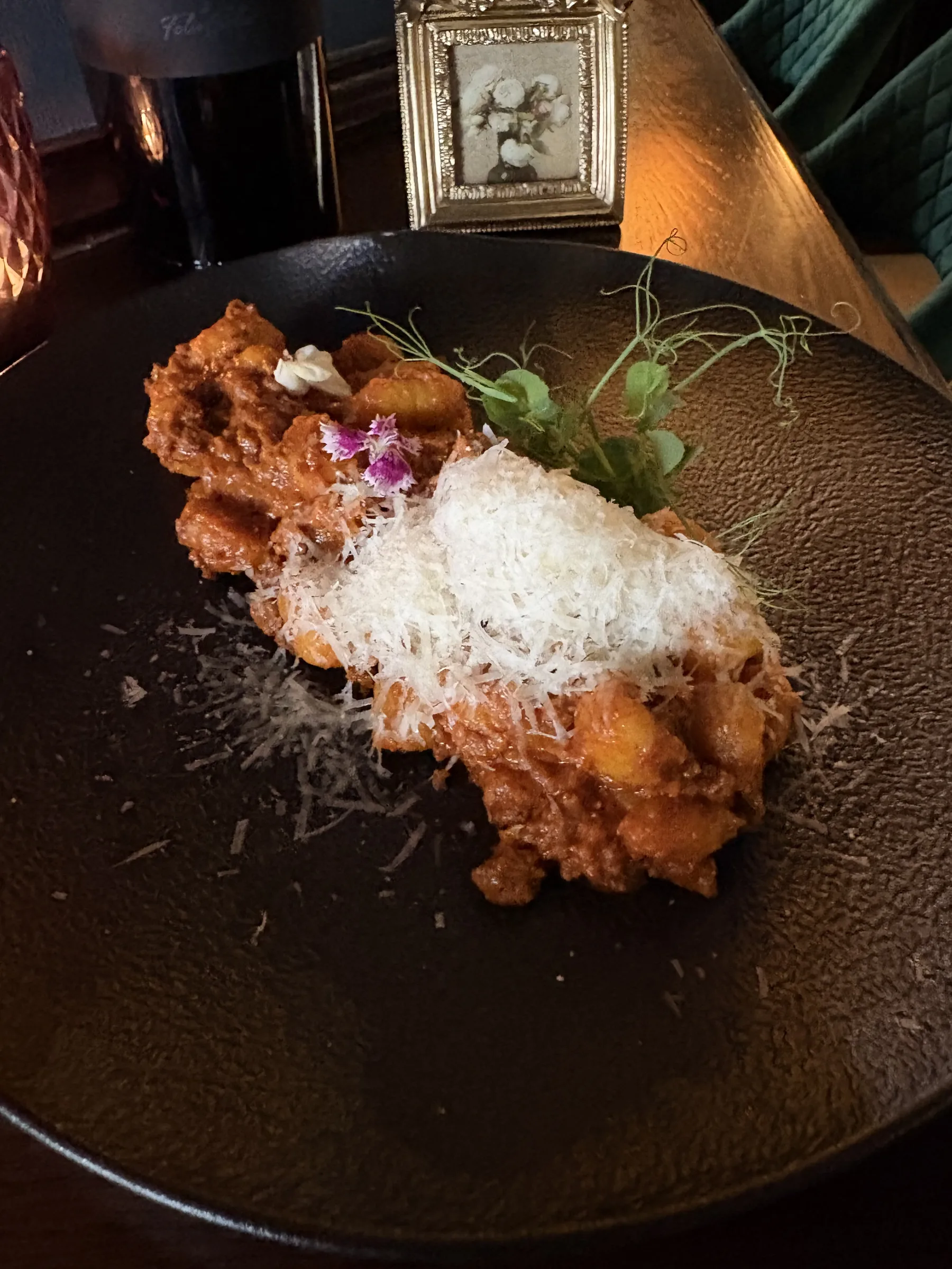 Pasta finished with grated cheese and an edible flower