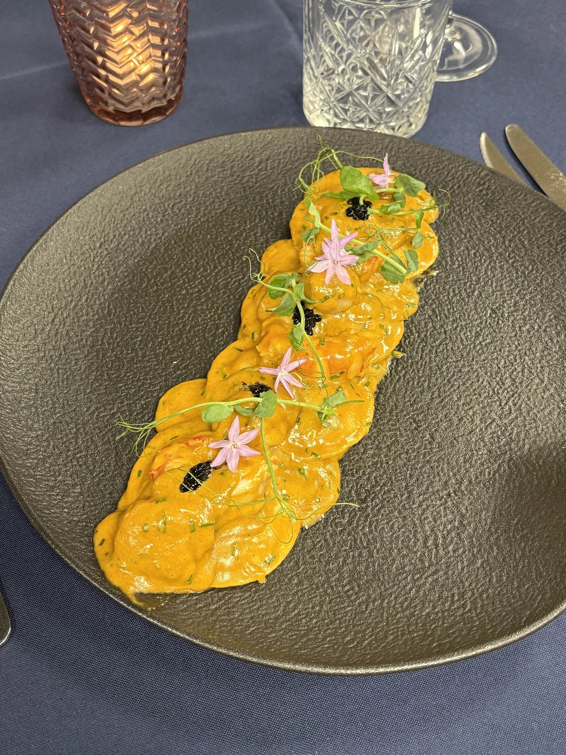 Shrimp presented in a vivid orange sauce